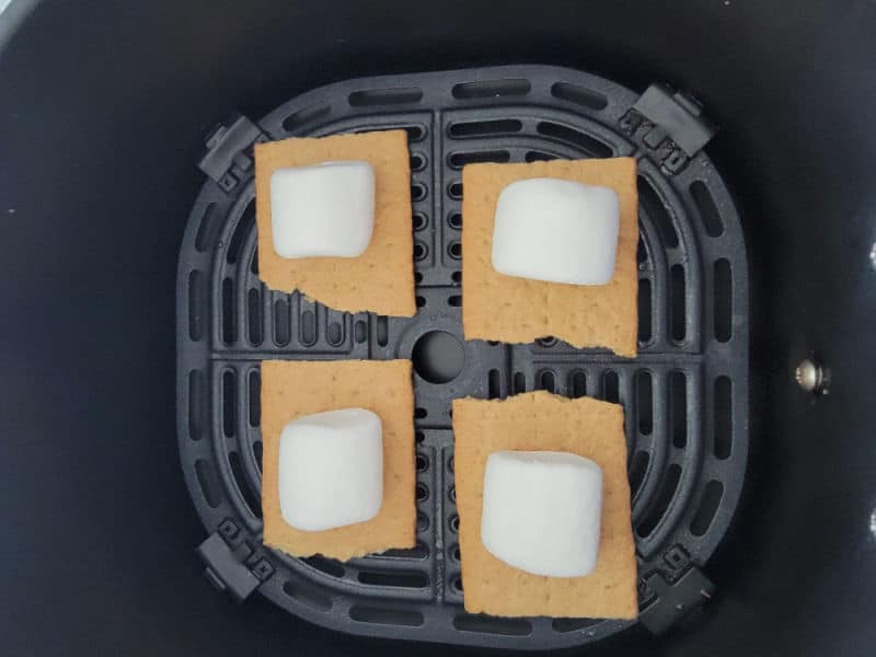 Marshmallows on graham cracker squares in an air fryer. 