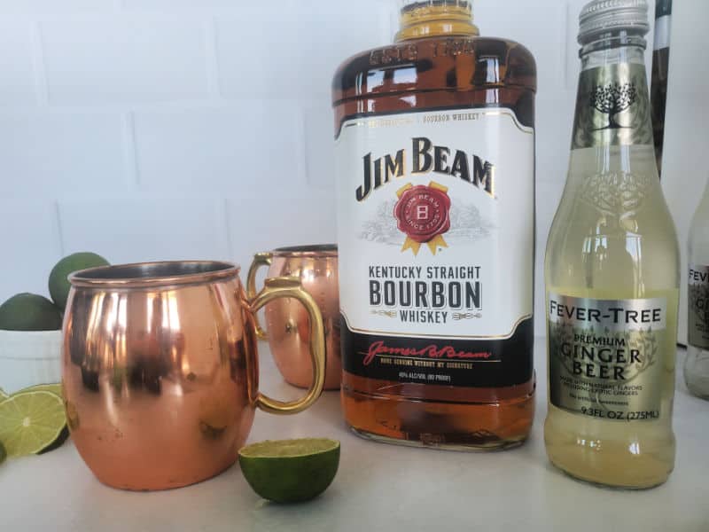 Kentucky Mule Ingredients, copper mug, jim beam bourbon, limes, fever tree ginger beer. 