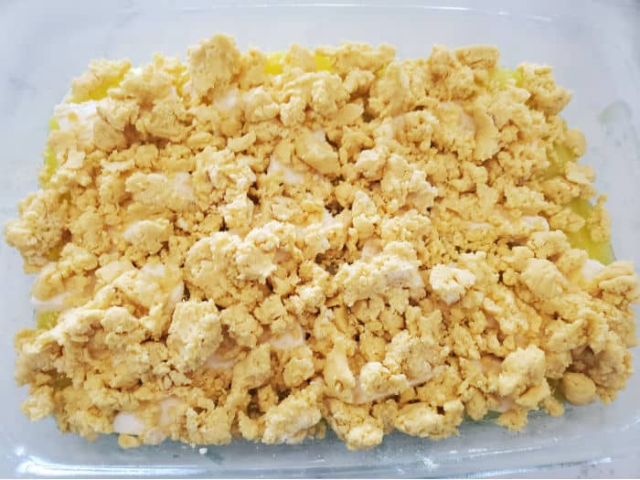 yellow cake mix crumble in a glass baking dish 