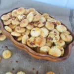 spicy oyster crackers in a wooden bowl on a burlap cloth