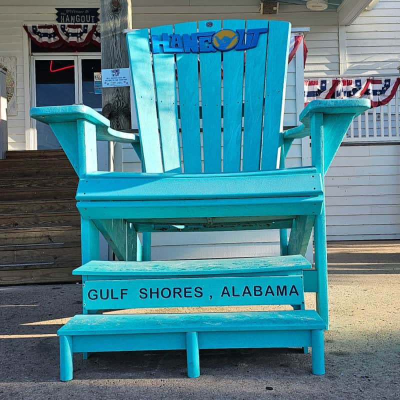 Blue Adirondack chair with The Hangout Gulf Shores, Alabama printed on it