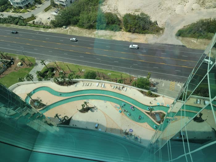 Looking down on a lazy river, road, and sand dunes