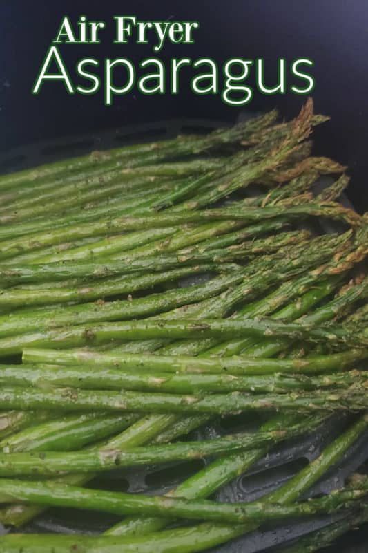 Air Fryer Asparagus over a bundle of asparagus in the air fryer