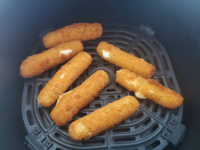 Air fried mozzarella sticks in the air fryer basket