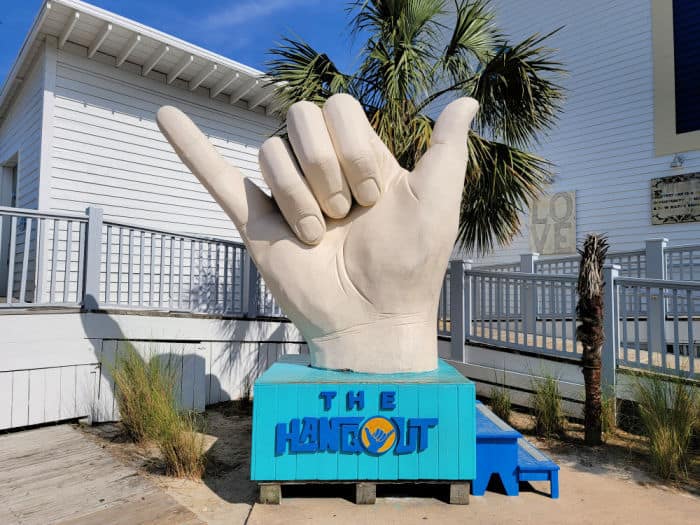 Shaka hand statue with The Hangout printed below it