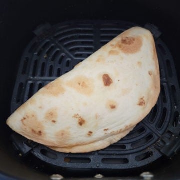 air fried quesadilla in an air fryer basket.