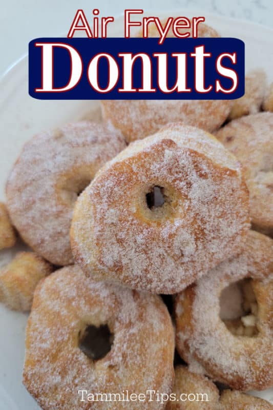 Air fryer donuts text written over a plate filled with cinnamon sugar coated air fryer doughnuts