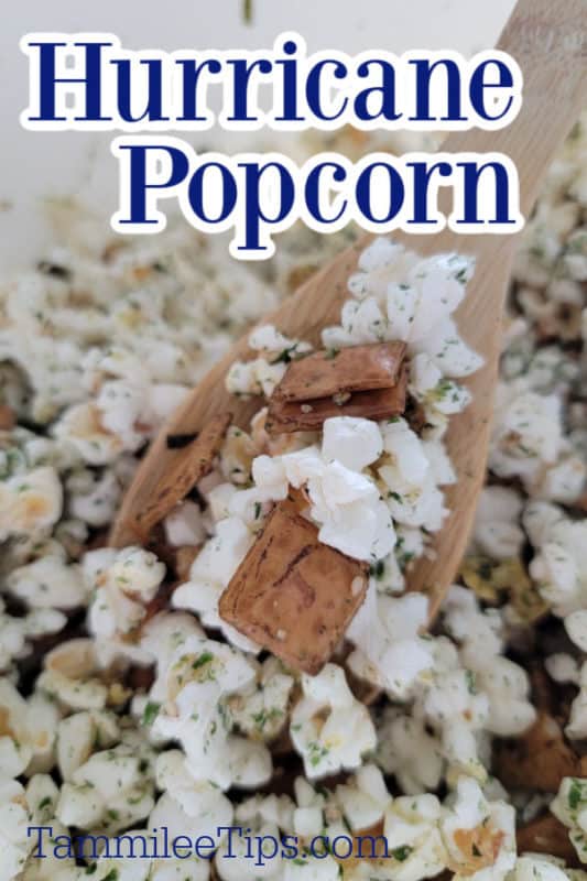 Hurricane Popcorn over a wooden spoon holding popcorn mix