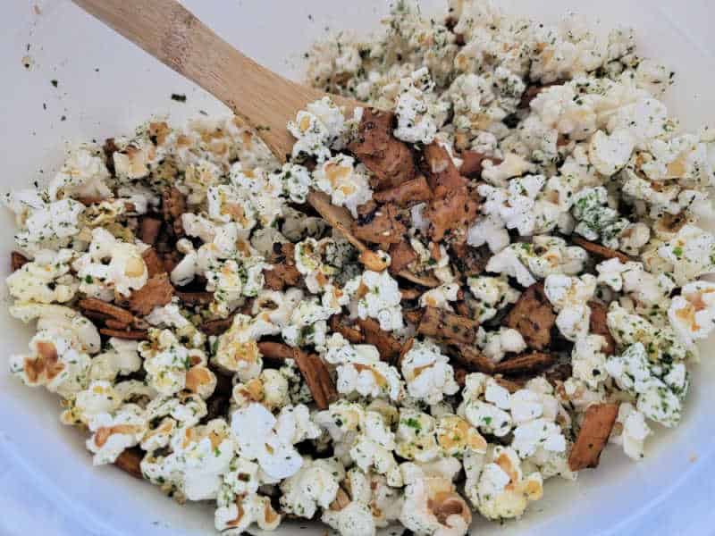 Large white bowl with Hawaiian Hurricane Popcorn and a wooden spoon