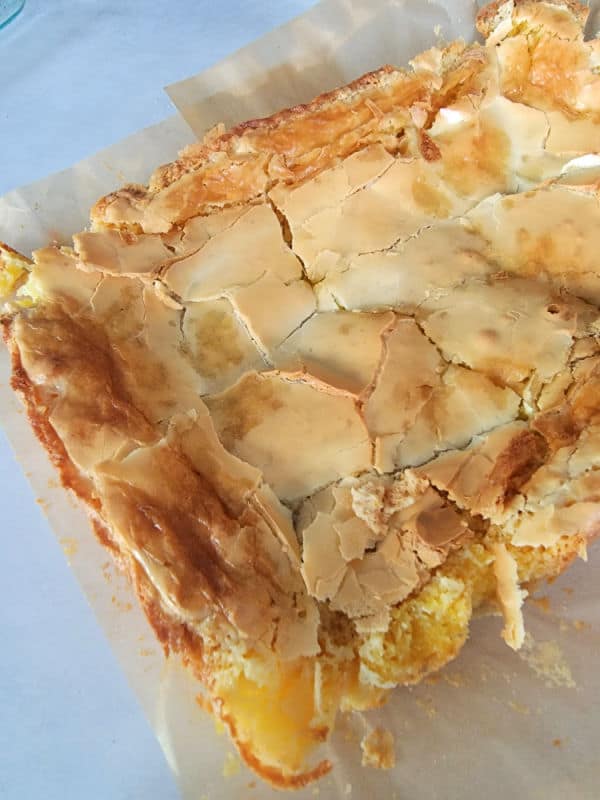 ooey gooey butter cake bars on parchment paper 