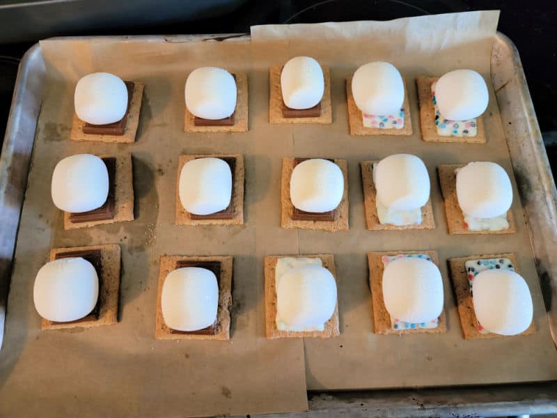 Oven smores on parchment paper on a baking sheet. 