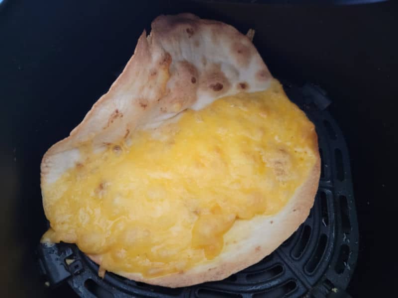 cooked air fryer quesadilla in the air fryer basket