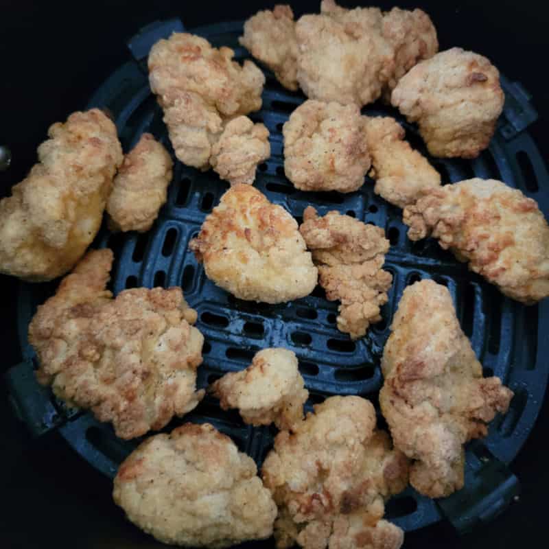 popcorn chicken in an air fryer basket