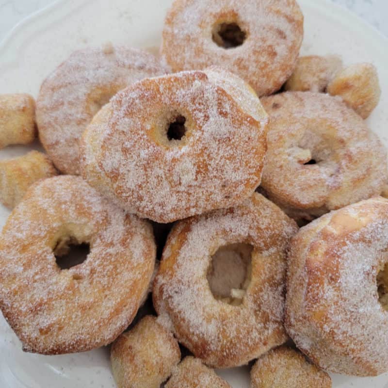 Quick And Easy Air Fryer Donuts piled on a white plate