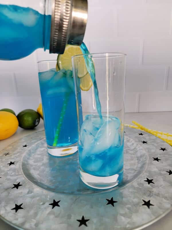 Electric Blue Lemonade pouring into a cocktail glass from a cocktail shaker