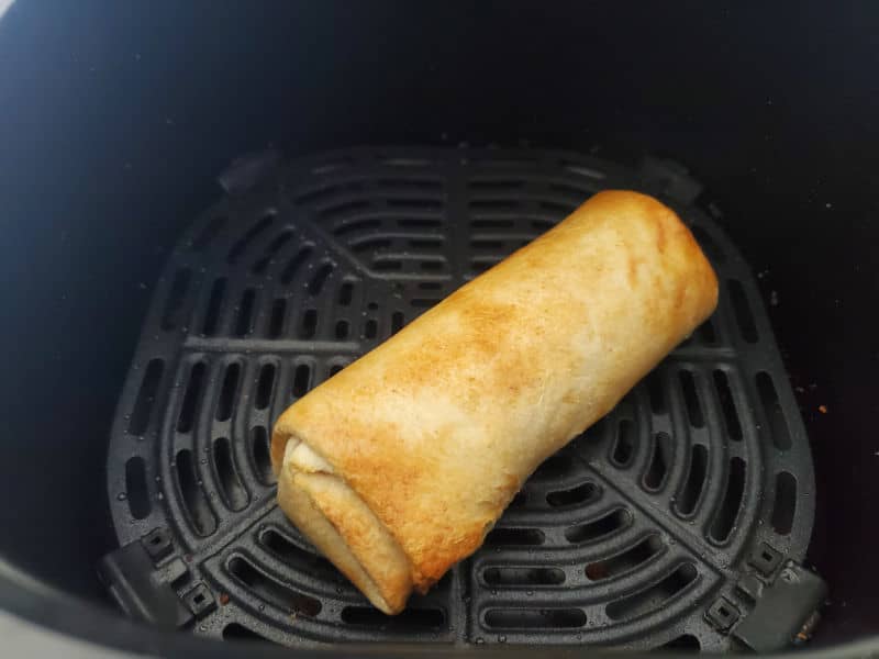 Air fried frozen burrito in the air fryer basket