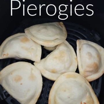 Air Fryer Pierogis text over an air fryer basket with frozen piergoies