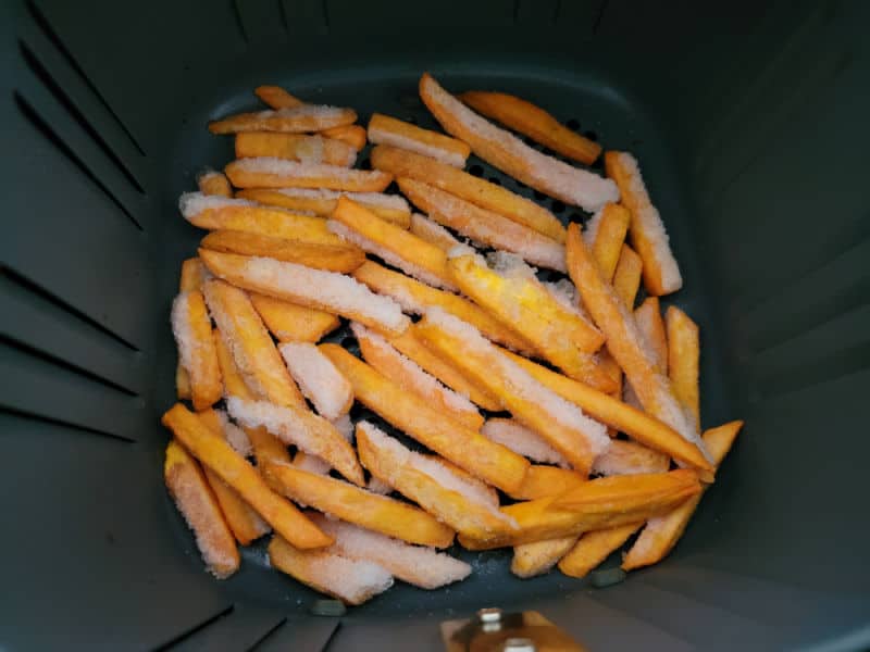 Frozen Sweet potato fries in an air fryer basket