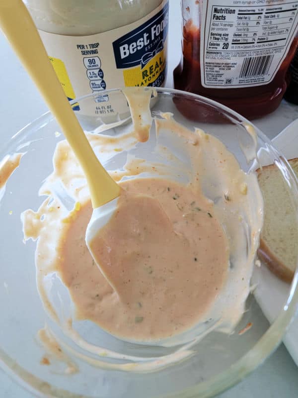 mayo and ketchup containers next to a glass bowl with In n Out Burger Spread and a spatula