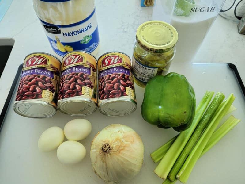 mayo, cans of kidney beans, green pepper, onion, hard boiled eggs, sugar, and celery stalk 