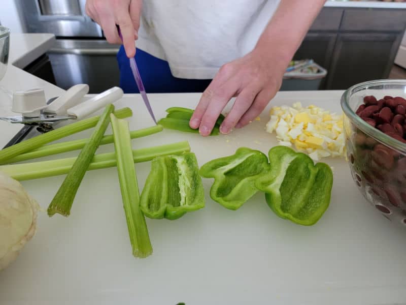 celery stalks and green peppers on a cutting board next to hard boiled eggs