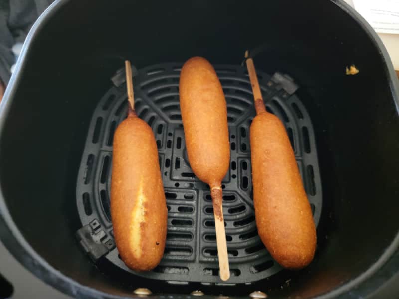 air fried corn dogs in an air fryer basket