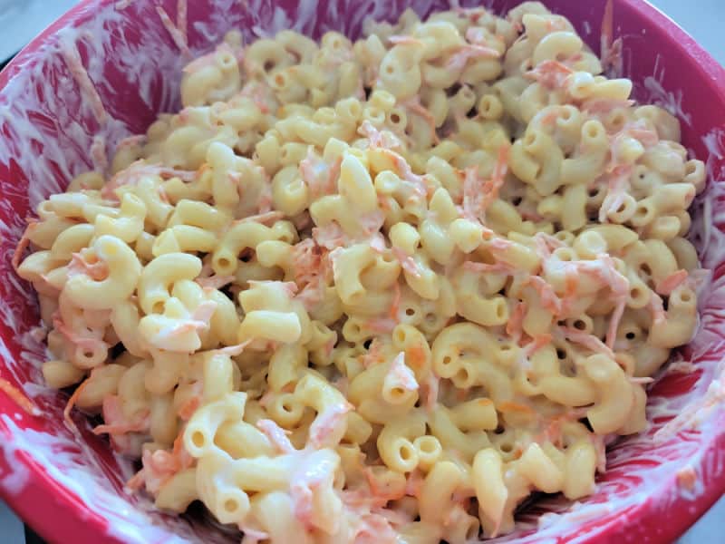 Macaroni with mayo and carrots in a red bowl 