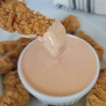 3 Ingredient Japanese Spicy Mayo on a chicken finger above a bowl filled with spicy mayo