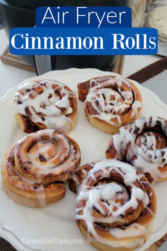 Air Fryer Cinnamon Rolls text over a white plate with cinnamon rolls covered in frosting