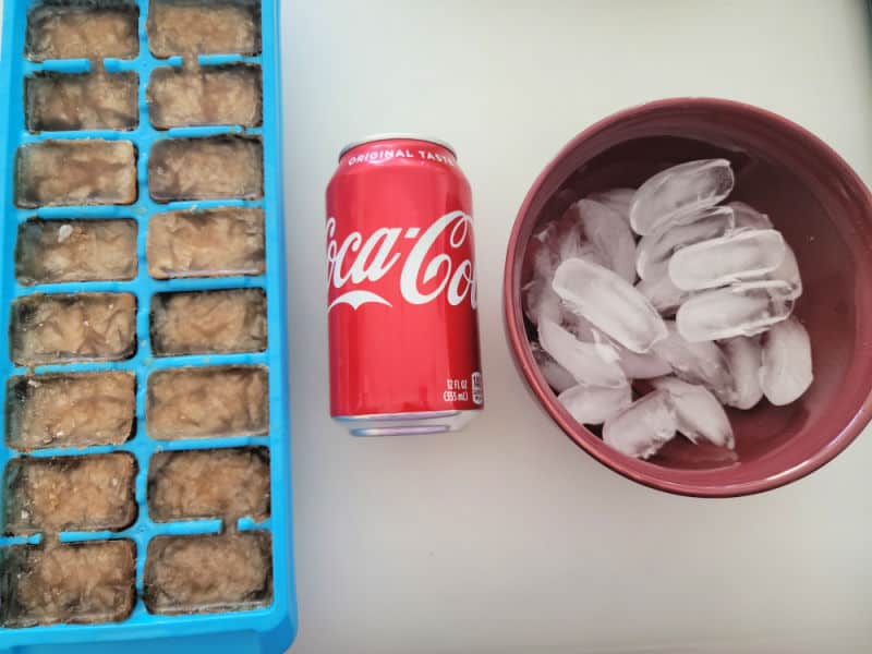Coke ice cubes, can of Coca Cola, and bowl of ice cubes