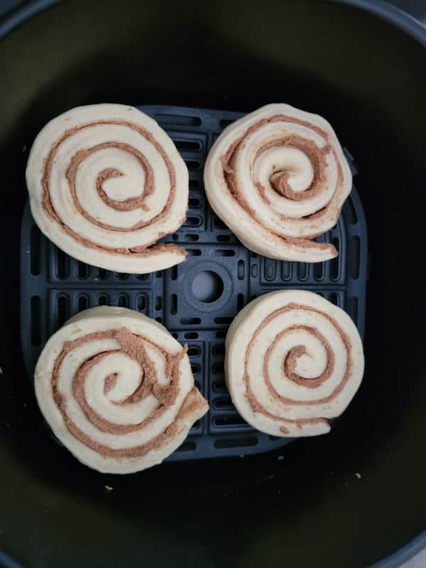Cinnamon roll dough in an air fryer basket