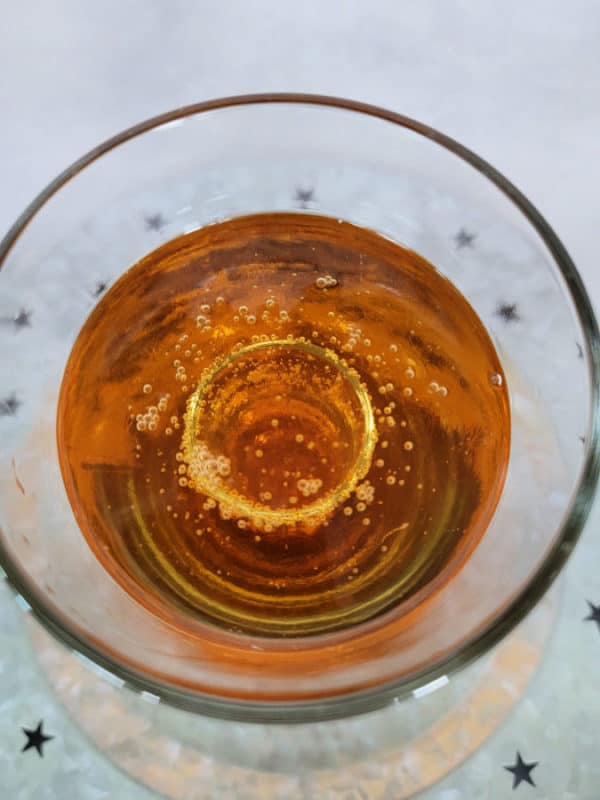 Looking down into a shot glass in a glass with liquid in it