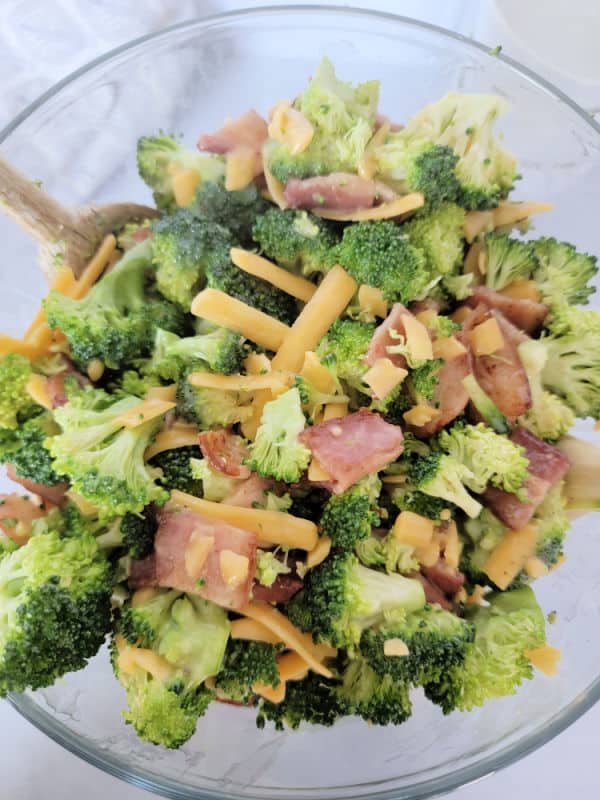 Broccoli salad with bacon and cheese in a glass bowl 
