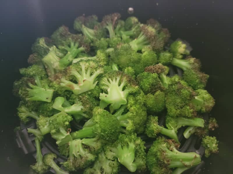 Air fried broccoli in the air fryer basket