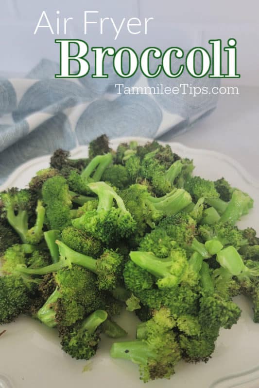 Air fryer broccoli over a white plate with air fried broccoli next to a cloth napkin