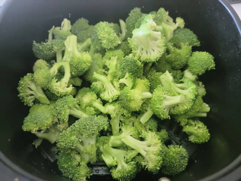 Broccoli in an air fryer basket