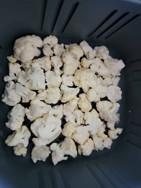 Cauliflower florets in the air fryer basket 