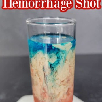 Alien Brain Hemorrhage Shot text over a red, cream, and blue cocktail shot on a coaster