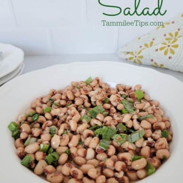 black eyed pea salad in a white bowl next to a cloth napkin
