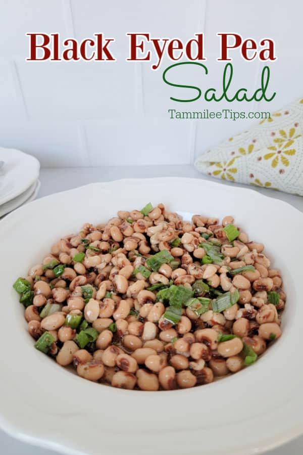 black eyed pea salad in a white bowl next to a cloth napkin