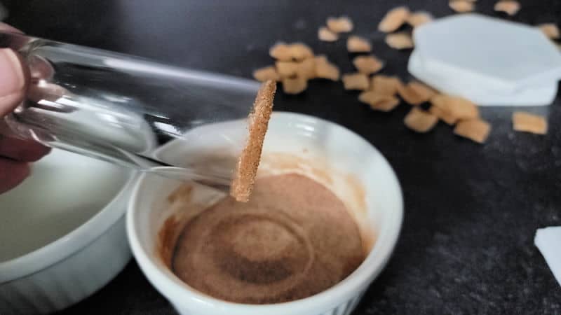 Cinnamon sugar rimmed glass shot glass over a bowl