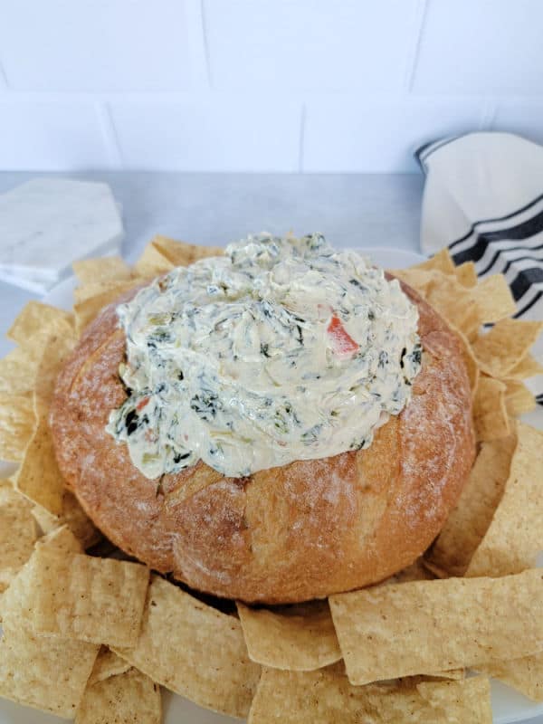 Knorr Spinach Dip in a bread bowl, surrounded by tortilla chips
