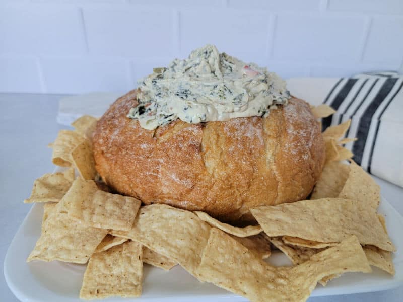 Knorr Spinach Dip in a bread bowl, surrounded by tortilla chips