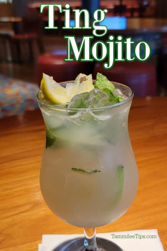 Ting Mojito Cocktail in a hurricane glass with lemon and mint floating on top. 