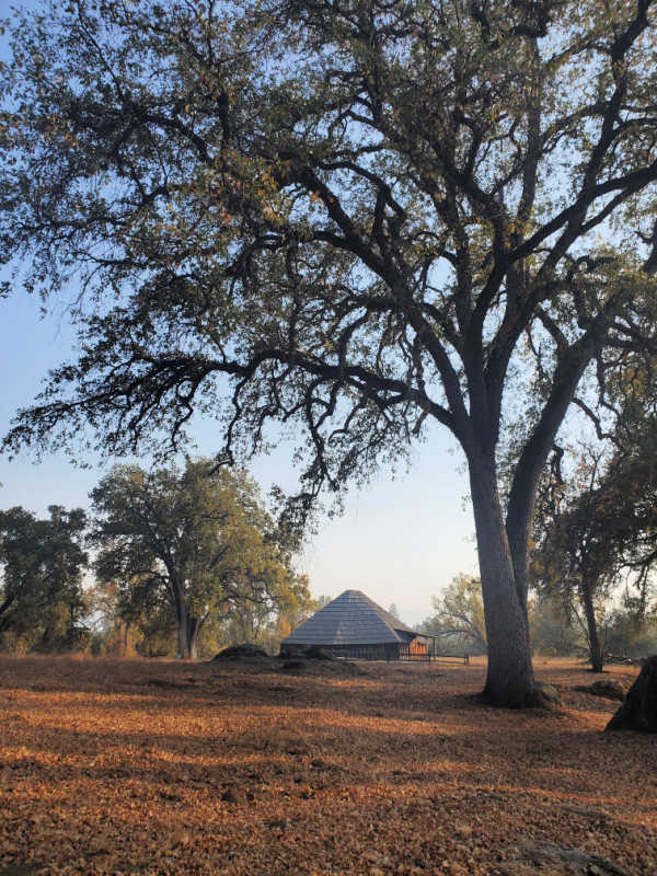 Historic roundhouse surrounded by trees and fall leaves