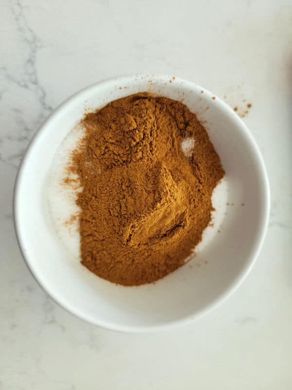 Ground cinnamon and white sugar in a bowl for the perfect cinnamon sugar ratio