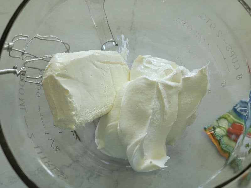 cream cheese and sour cream in a glass bowl