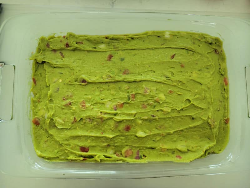 Guacamole spread in a glass baking dish