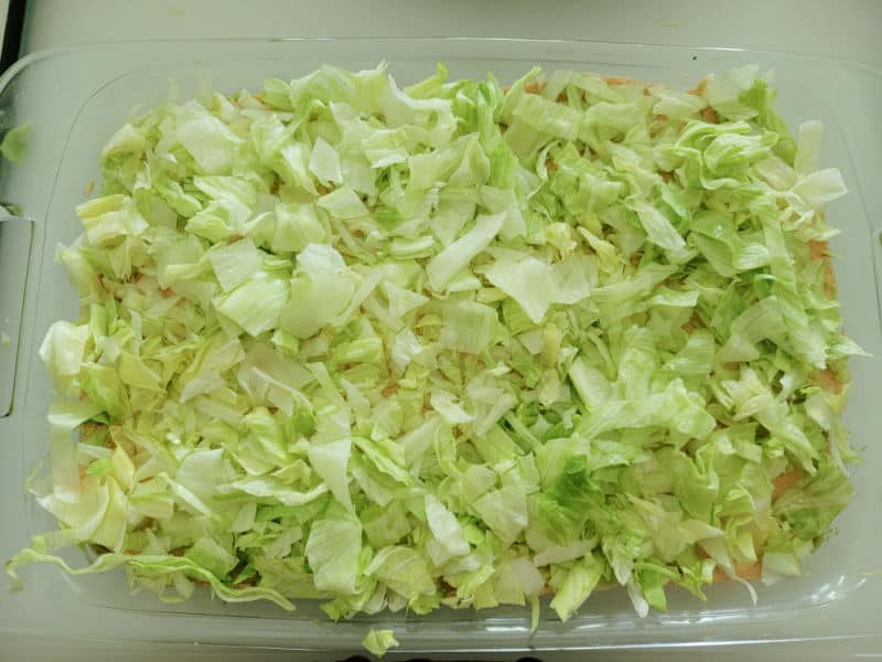 Shredded lettuce spread in a baking dish