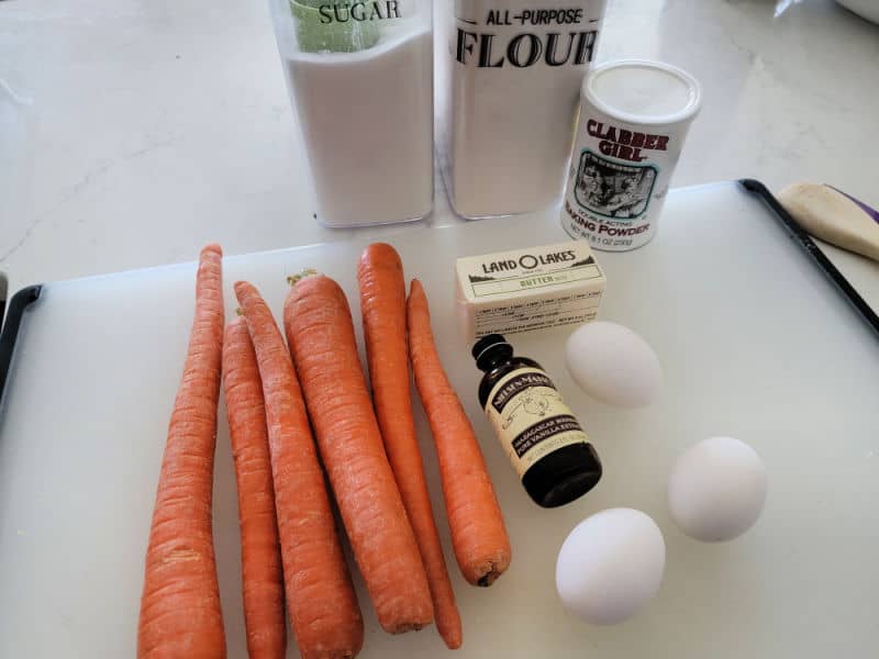 Carrot souffle ingredients, fresh carrots, vanilla, eggs, butter, baking powder, sugar, and flour